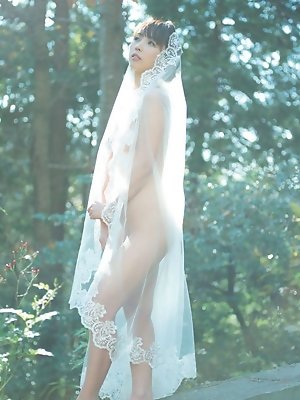 Neo Asian in long dress goes to enjoy reading book in the forest